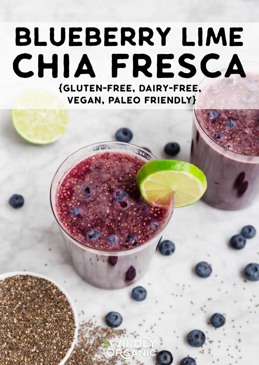 Two glasses of blueberry chia fresca with lime wedge, surrounded by blueberries and chia seeds.