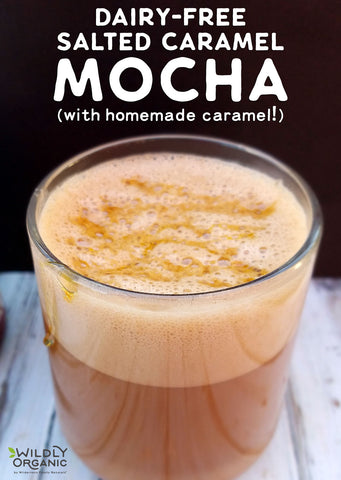 A glass of dairy-free salted caramel mocha with frothy top and drizzled caramel