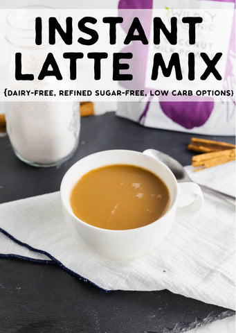 Photo of a mug with coffee in it with a bottle of instant latte mix and coconut milk powder.
