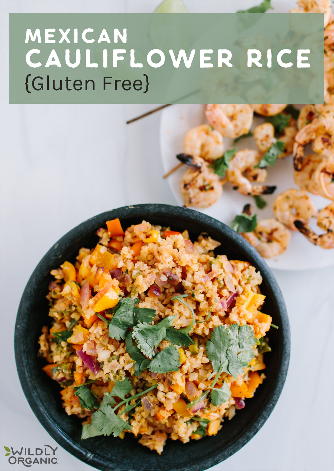 Mexican Cauliflower Rice {Gluten-Free} a bowl of Mexican cauliflower rice on a table with skewers of shrimp in the background