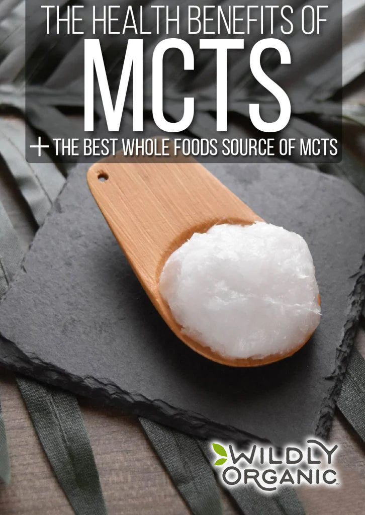 The Health Benefits Of MCTs + The Best Whole Foods Source Of MCTs | You may have seen the term MCTs pop up in various health circles. It's been coined a 'fat-burning fat'. But wait for a second! Isn't that an oxymoron? Consuming MCTs has been attributed to speeding up the body's metabolism and burning more fat. Discover the best wholefoods source of MCTs here! | WildernessFamilyNaturals.com Wooden spoon with coconut oil on slate, text: 'The Health Benefits of MCTs.' Wildly Organic logo in the corner