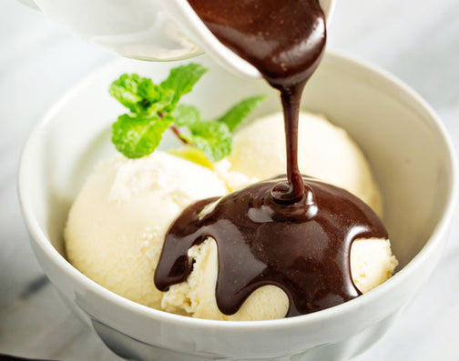 Vegan chocolate syrup being poured onto ice cream